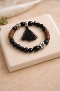 Bracelet perles noires avec pompon – Élastique
